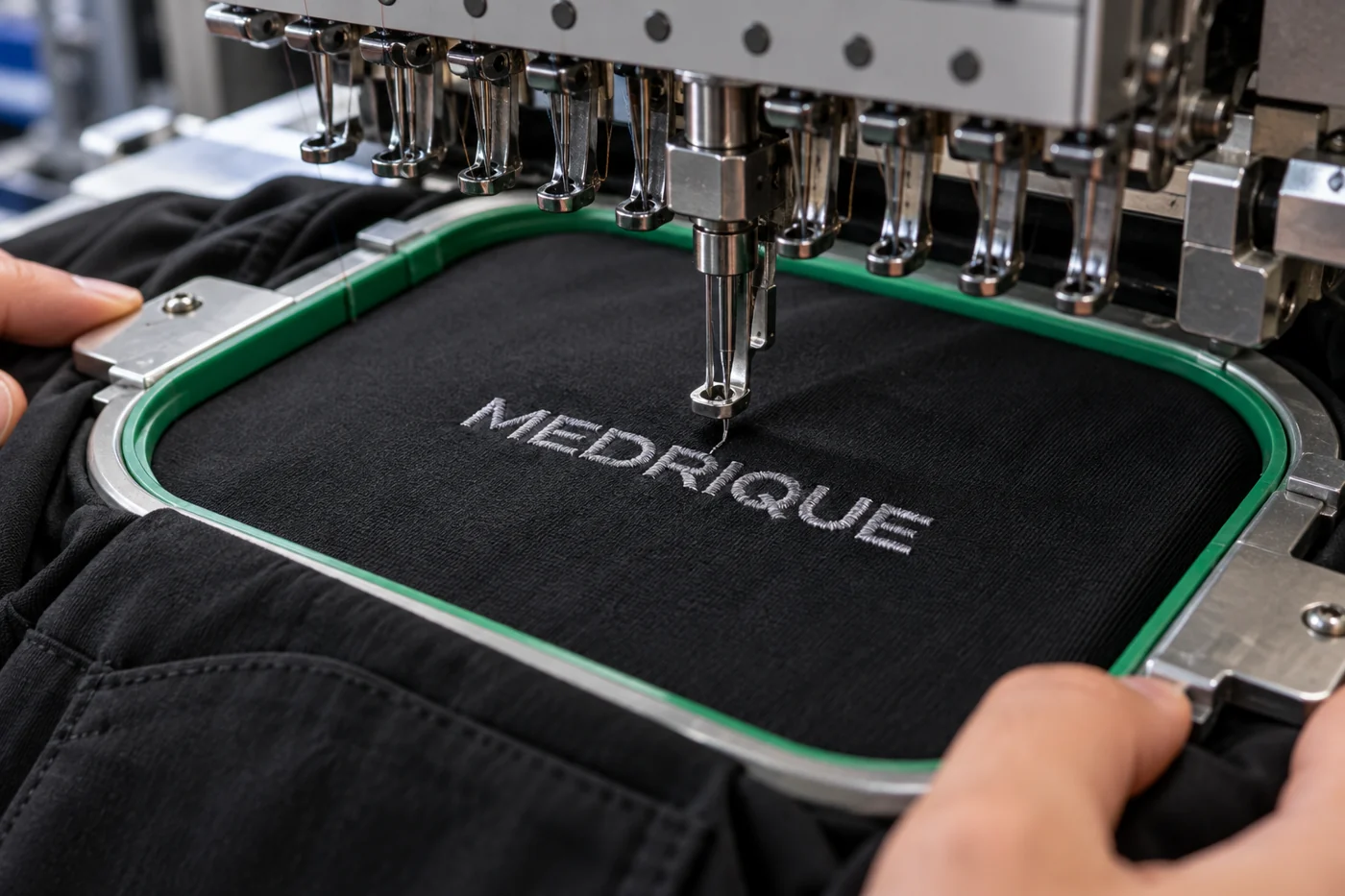Medrique embroidery stitched on black scrub fabric