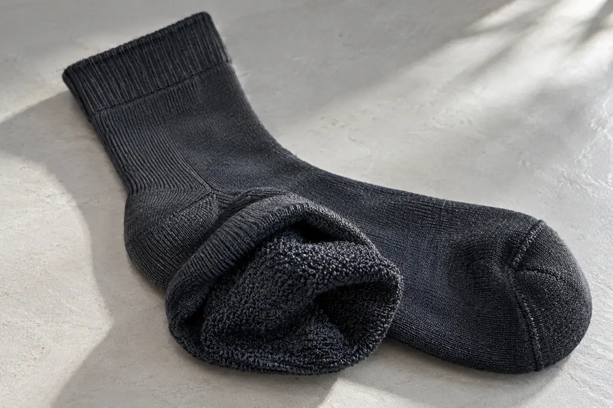 Charcoal crew sock showing cushioned terry loops at the sole