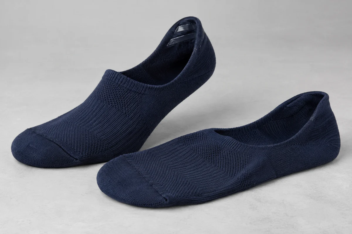 Navy no-show scrub socks with shaped heel openings